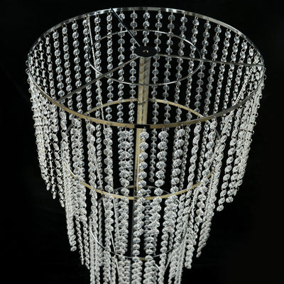 Crystal chandelier with hanging beads on a black background.