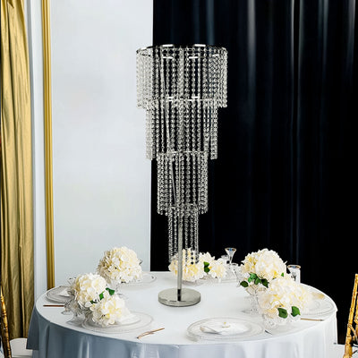 Elegant crystal chandelier on a dining table with floral decor.