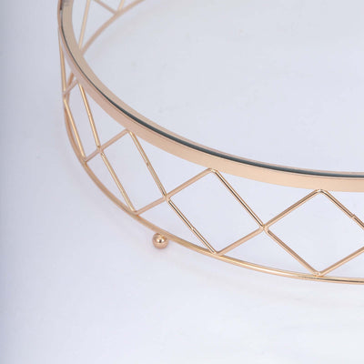 Gold geometric wire basket with glass top on a white background