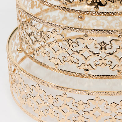 Elegant gold three-tier cake stand with intricate lace design.