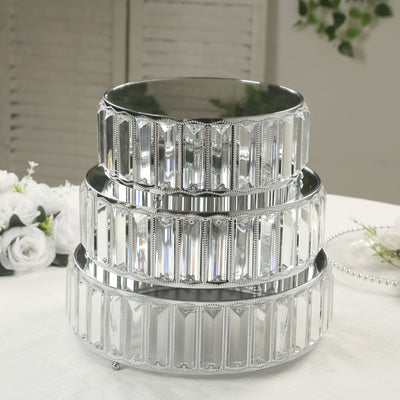 Three-tiered mirrored cake stand in a decorative design.