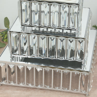 Stacked decorative trays with mirrored surfaces and elegant detailing.