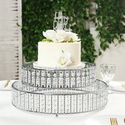 Elegant three-tier cake stand with white cake and floral decoration.