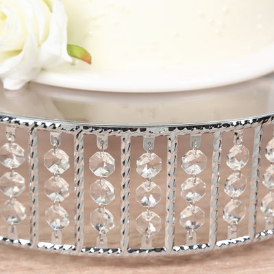 Elegant silver cake stand with crystal accents and floral decoration.