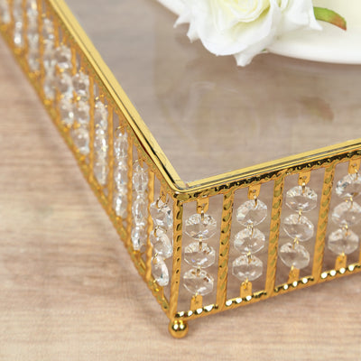 Gold and crystal decorative tray with elegant design and glass top.