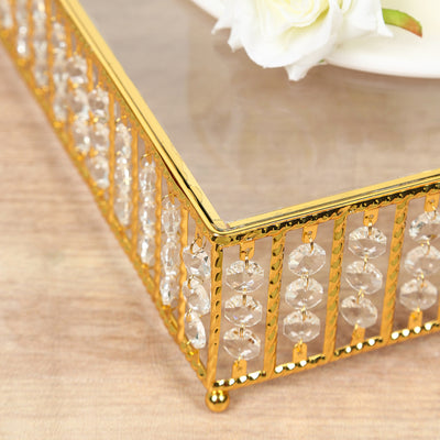 Gold and crystal decorative tray with elegant design on wooden surface.