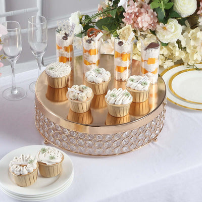 Elegant desserts on a gold display stand at a festive table setting.