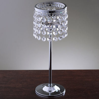 Elegant crystal table lamp with chrome base and decorative fringe.