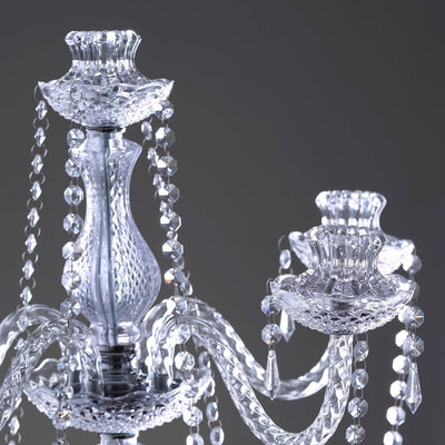 Elegant crystal chandelier with intricate detailing and hanging beads.