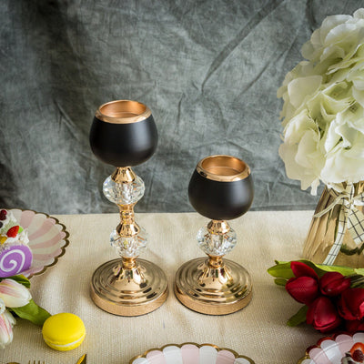 Elegant gold and black candle holders with crystal accents.
