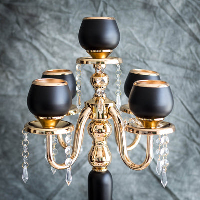 Elegant black and gold candelabra with crystal accents.