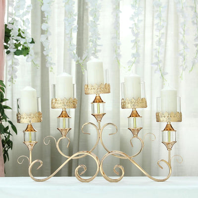 Elegant gold candle holder with glass cups and white candles, perfect for decor.