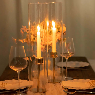 Elegant candle holders with lit candles and floral decor on a dining table.
