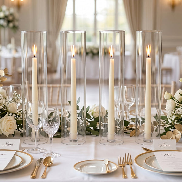 Elegant wedding table setting with candles, gold accents, and white roses