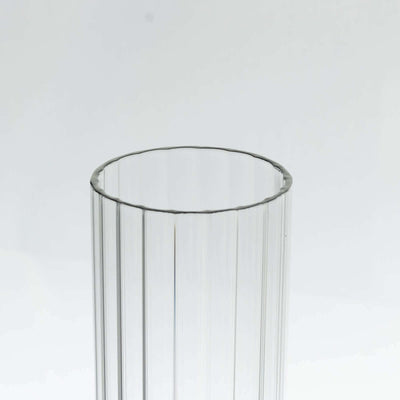 Clear ribbed glass vase with a smooth rim.