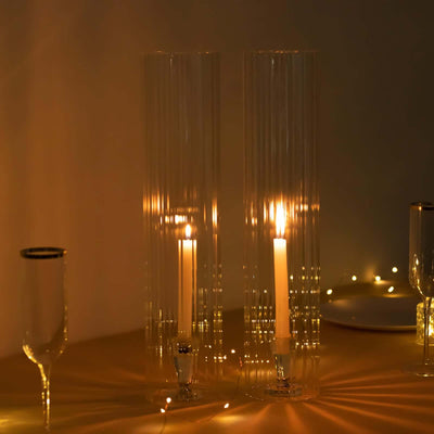 Elegant glass candle holders with lit candles, creating a warm ambiance.