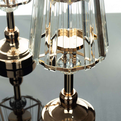 Elegant crystal table lamp with gold accents, reflecting light beautifully.