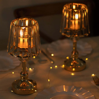 Elegant gold table lamps with crystal shades illuminating a dining setting.