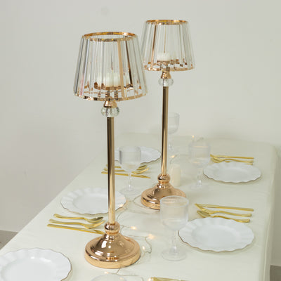 Elegant rose gold table lamps with pleated shades on a dining table setting.