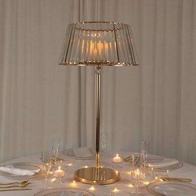 Elegant table lamp with a glass shade and gold accents on a dining table.