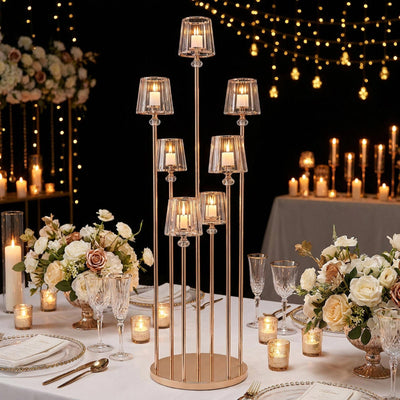 Elegant wedding table centerpiece with gold candle holders and floral arrangements