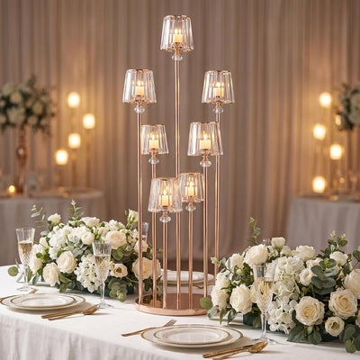 Elegant wedding table centerpiece with candles, white roses, and gold candelabra altar.