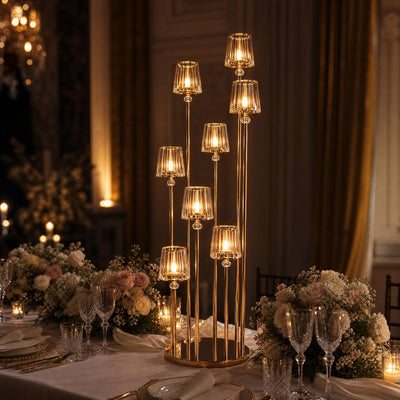 Elegant gold candle holder centerpiece on a luxury wedding table
