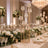 Elegant luxury wedding table centerpiece with gold candle holders and white flowers