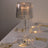 Elegant striped table lamp illuminating a dining setting with gold cutlery and glassware.