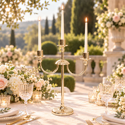 Elegant outdoor wedding table with gold candelabra and floral centerpieces