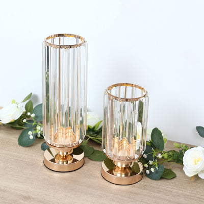 Rose gold crystal candle holders with floral arrangement on wooden table