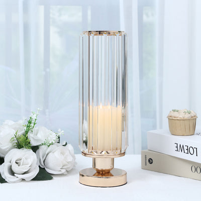 Elegant gold crystal glass candle holder with lit candle and white flowers