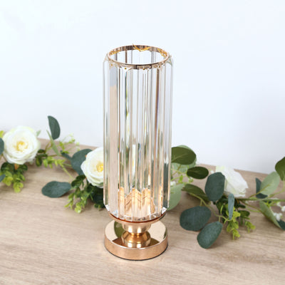 Gold crystal cylinder vase centerpiece with white roses and eucalyptus greenery