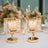 Elegant gold and crystal candle holders on a beautifully set dining table.