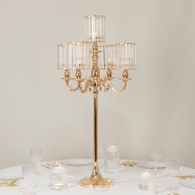 Elegant gold candelabra with glass shades, perfect for table decor.