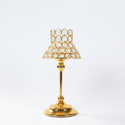 Gold table lamp with crystal accents on a plain white background