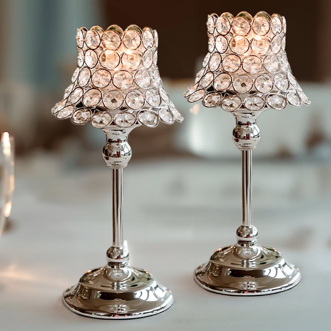 Elegant crystal candle holders with ornate bases and shimmering light reflections.