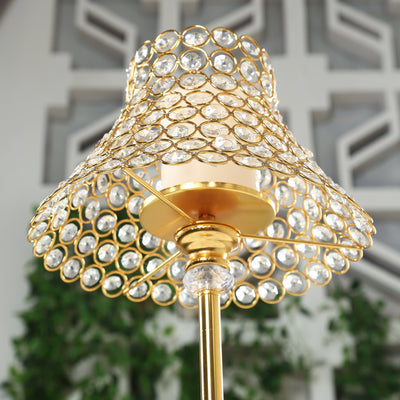 Elegant gold lamp with crystal embellishments and a unique shade design.
