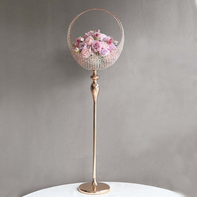 Rose flower arrangement in elegant crystal vase on a tall golden stand.