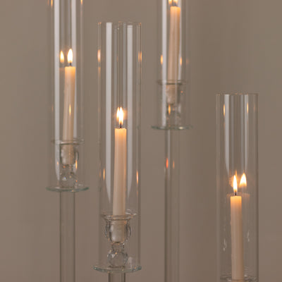 Elegant glass candle holders with lit candles