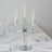 Elegant crystal candelabra with five candles on a dining table.