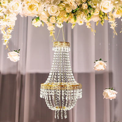 Crystal chandelier hanging amidst floral decor.