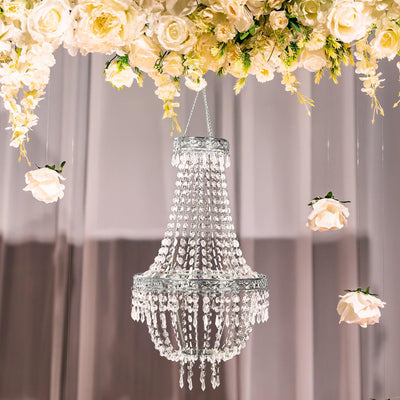 Elegant crystal chandelier hanging with floral decor.