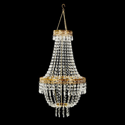 Elegant crystal chandelier with gold accents, suspended on a black background.