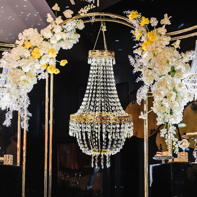 Elegant crystal chandelier adorned with flowers, showcasing intricate design and sparkle.