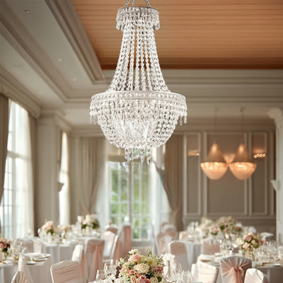Elegant crystal chandelier illuminating a beautifully arranged dining room.
