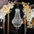 Elegant crystal chandelier adorned with flowers in a decorative setting.