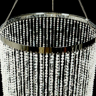 Elegant crystal chandelier with cascading beads and silver accents.