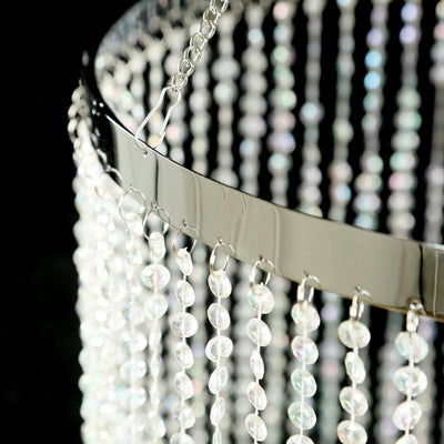 Crystal chandelier with hanging beads and silver frame.