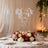 Elegant crystal chandelier above a beautifully arranged table with floral centerpieces.